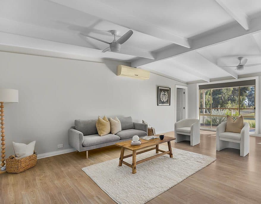 Living room fully styled for sale by Wisteria & Oak in Echuca, with sofa, armchairs and a soft neutral rug